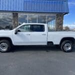 A white truck parked in front of a building.