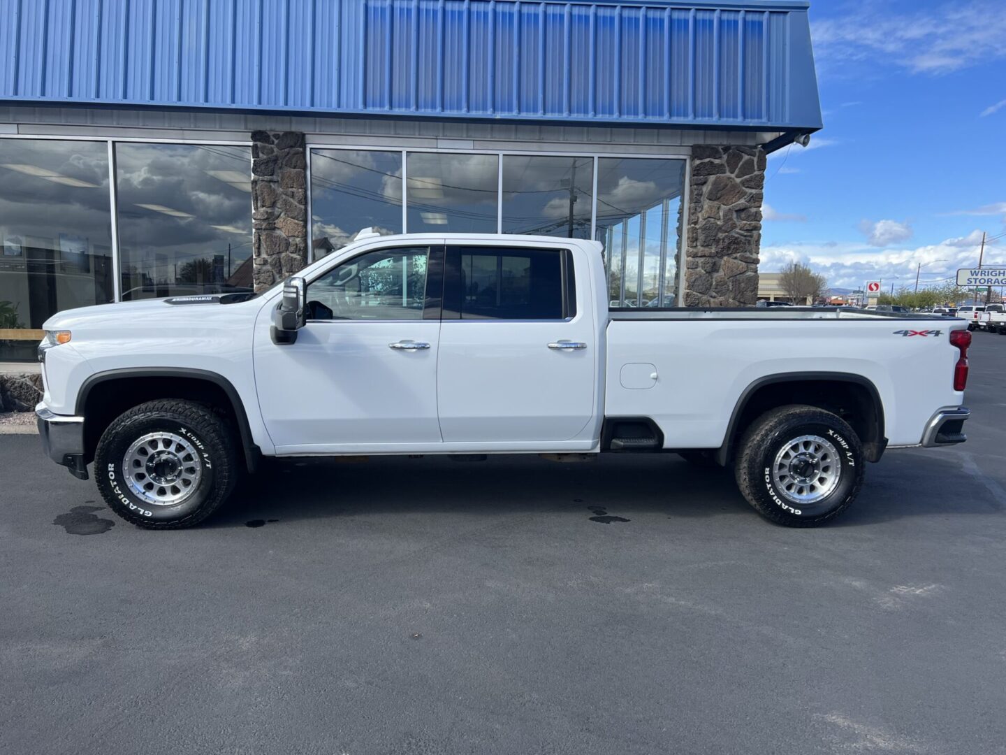 A white truck parked in front of a building.