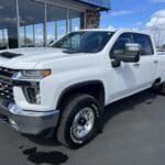 A white truck parked in front of a building.