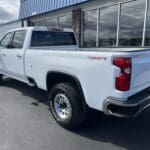 A white truck parked in front of a building.