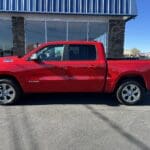 A red truck parked in front of a building.