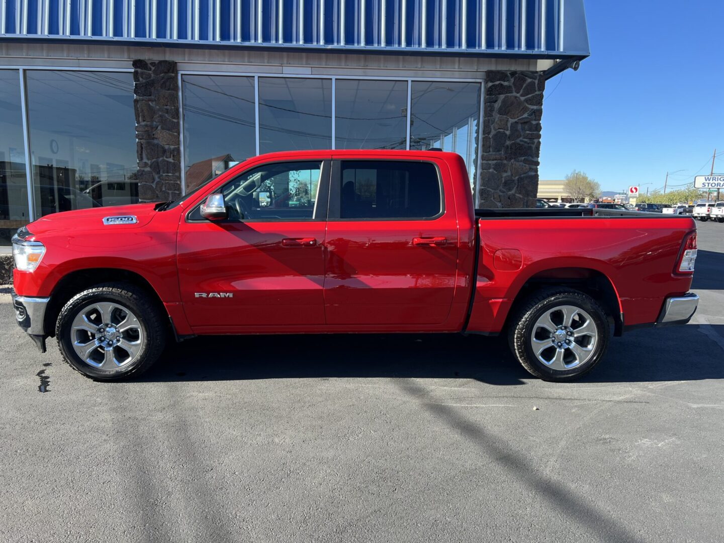 A red truck parked in front of a building.