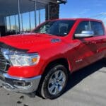 A red truck parked in front of a building.