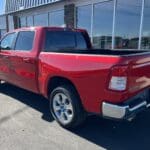 A red truck parked in front of a building.