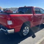 A red truck parked on the side of a road.