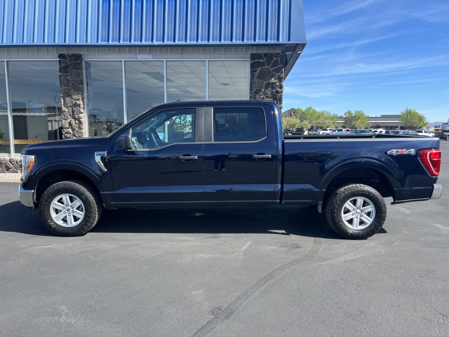 A black truck parked in front of a building.