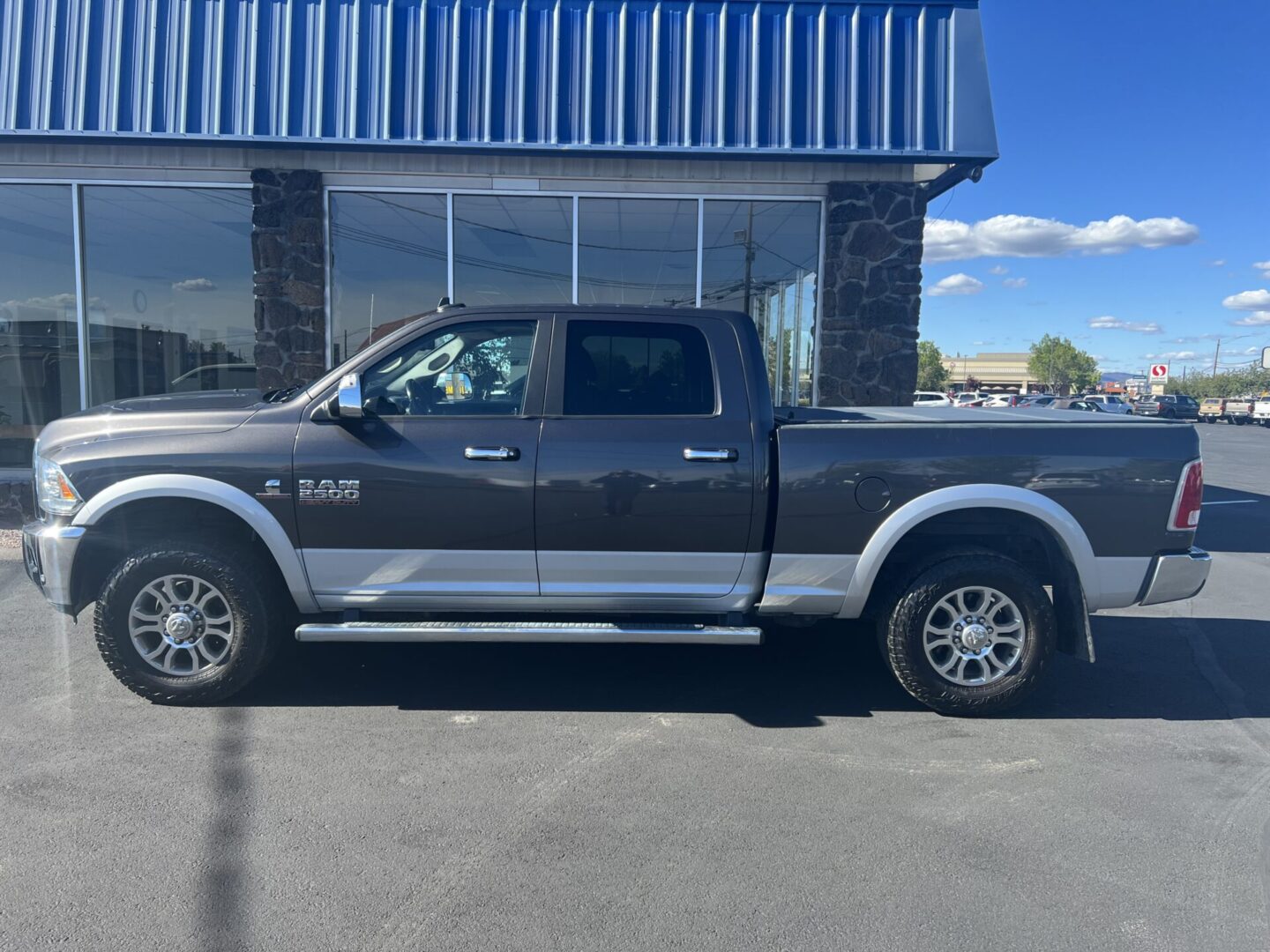 A gray truck parked in front of a building.