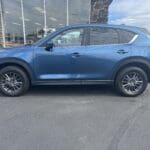 A blue mazda parked in the parking lot.