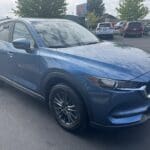 A blue mazda parked in the parking lot.