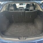 A trunk of a car with the back seats down.