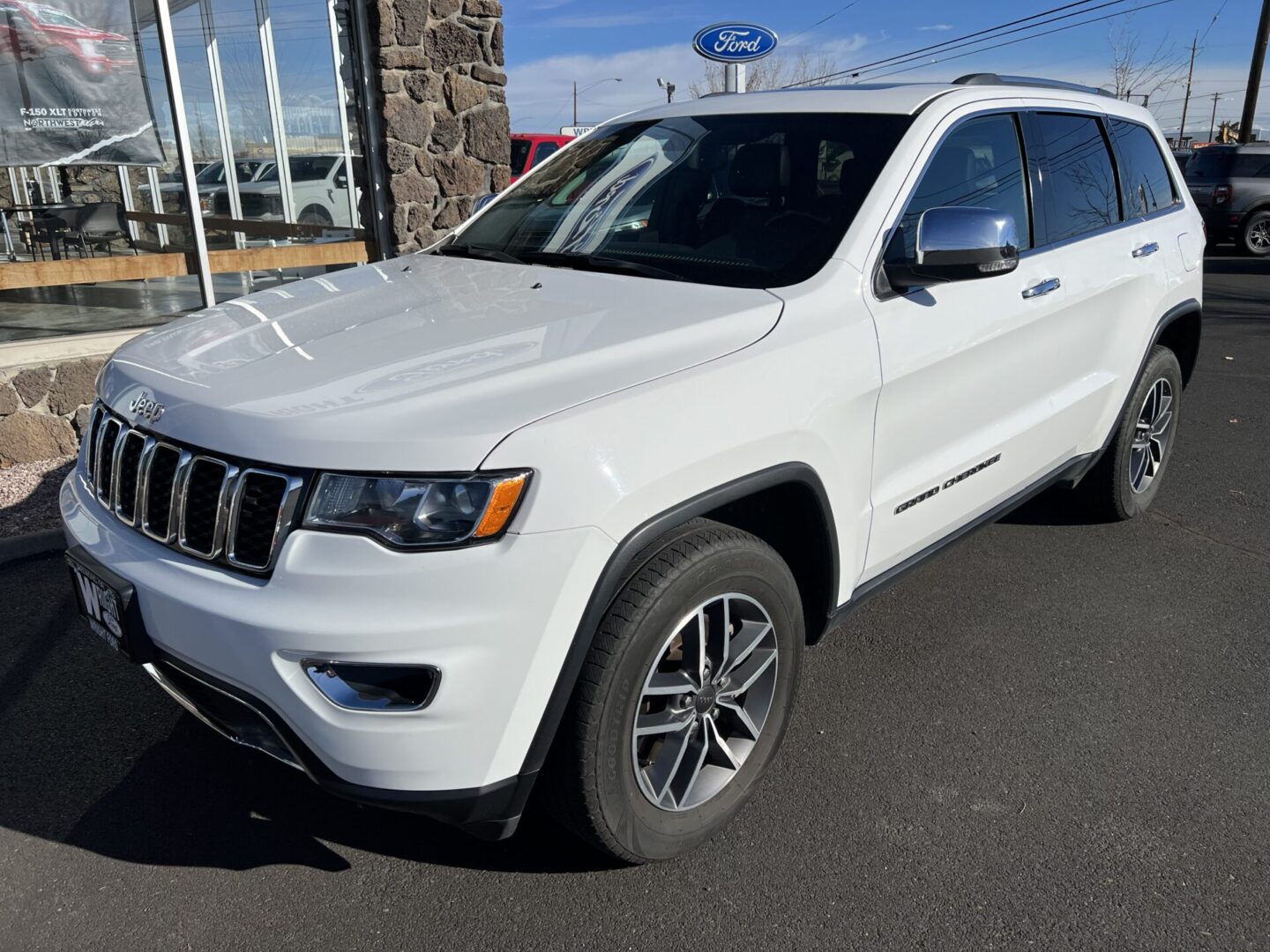 A white jeep parked in the parking lot.