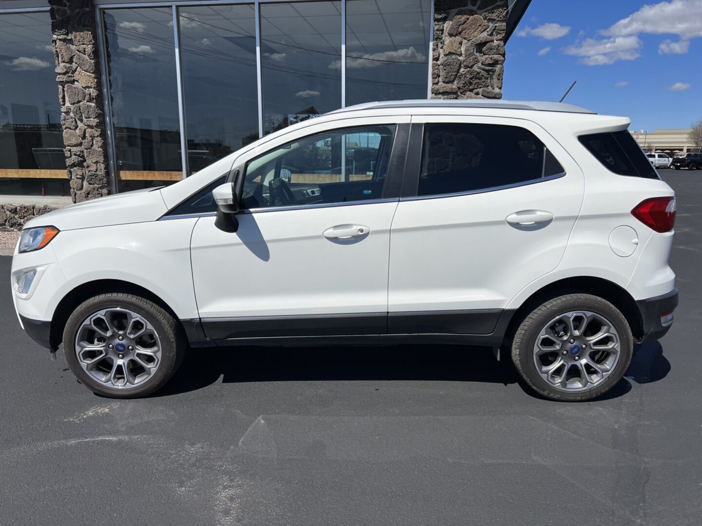 A white car parked in front of a building.