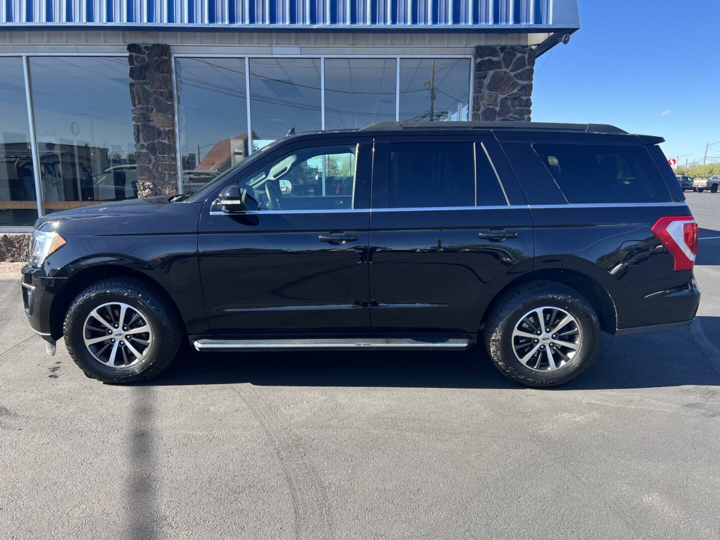 A black suv parked in front of a building.