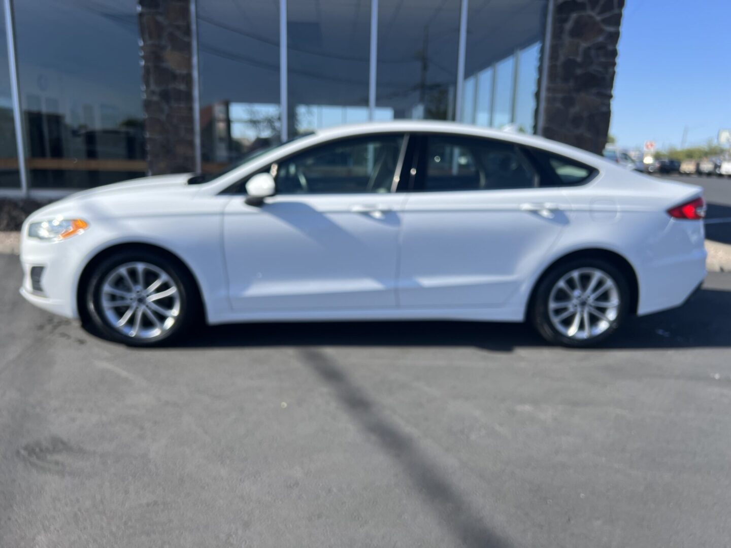 A white car parked in front of a building.