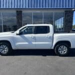 A white truck parked in front of a building.