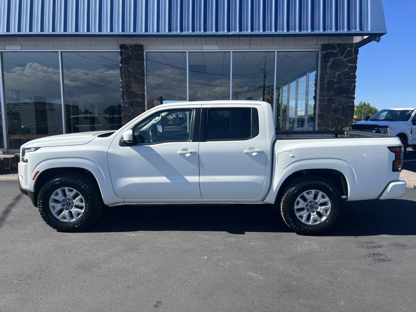 A white truck parked in front of a building.