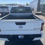 A white truck parked in the lot with other vehicles.