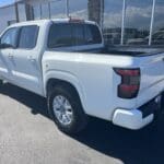 A white truck parked in front of a building.