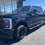 A black truck parked in front of a building.