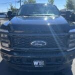 A black truck parked in the parking lot.