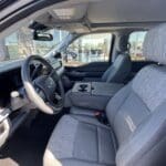 A truck with gray seats and a steering wheel.