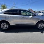 A silver car parked in the parking lot