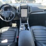 A dashboard of a car with the center console on.