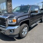 A black truck parked in front of a building.