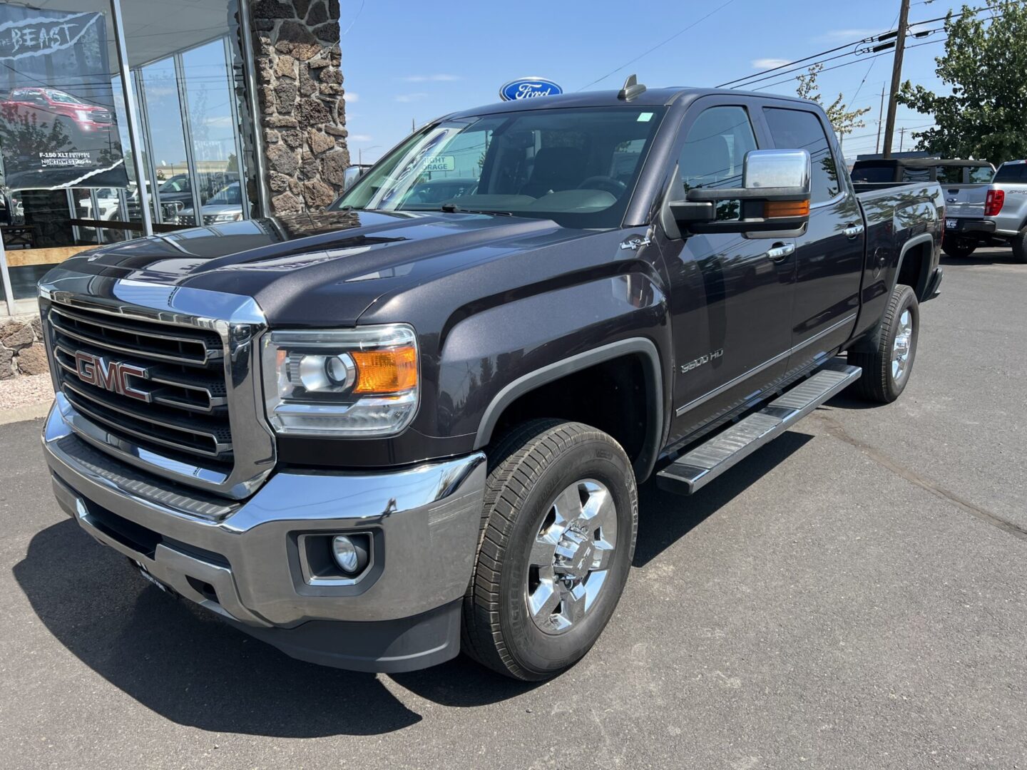 A black truck parked in front of a building.