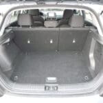 A trunk of a car with the back seats folded down.