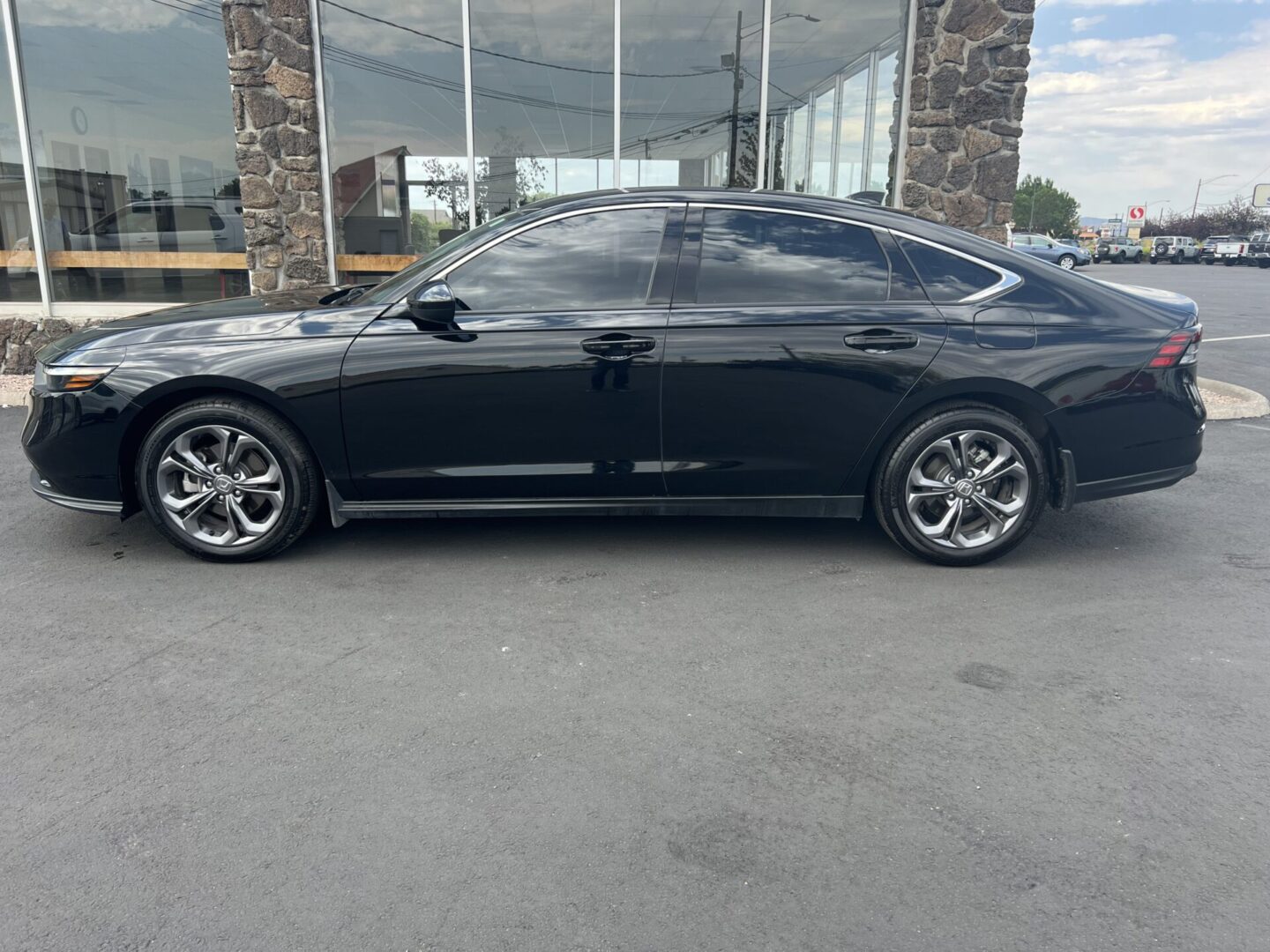 A black car parked in front of a building.