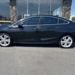 A black car parked in front of a building.