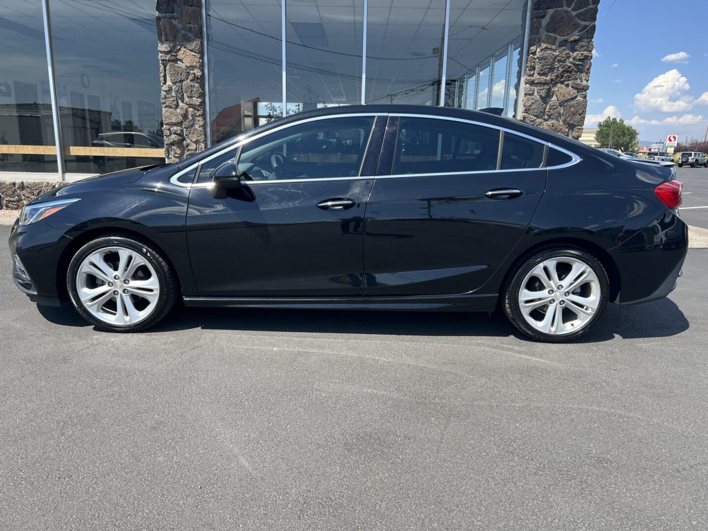 A black car parked in front of a building.