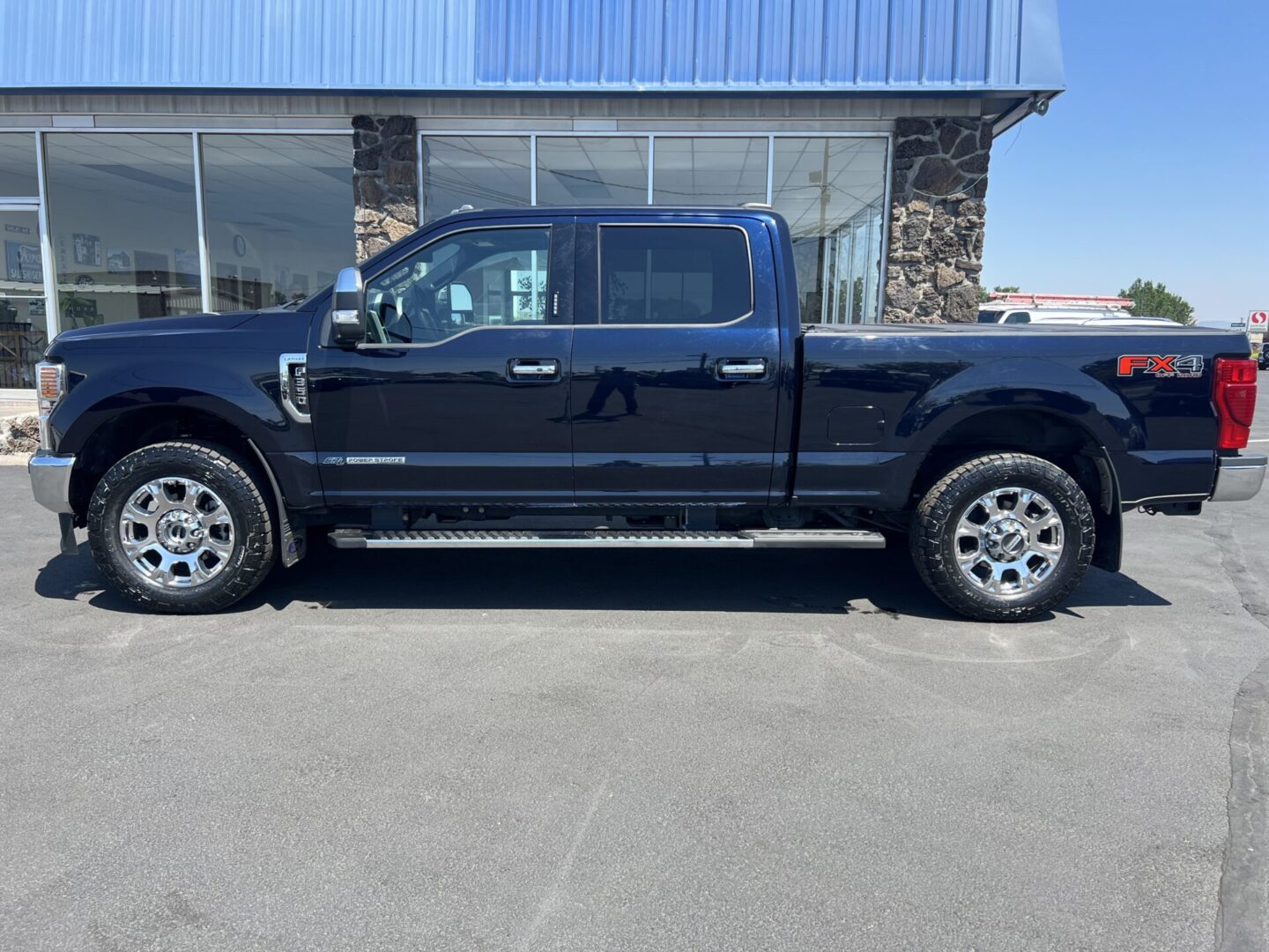 A black truck parked in front of a building.