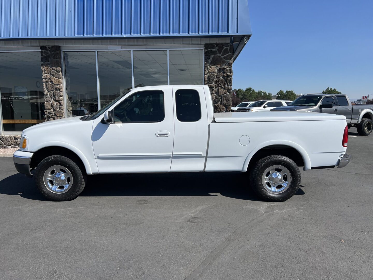 A white truck parked in front of a building.