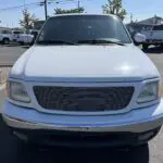 A white truck parked in a parking lot.