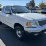 A white truck parked in the parking lot.