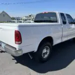 A white truck parked in the parking lot.