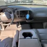 A car with the dashboard and steering wheel in it.