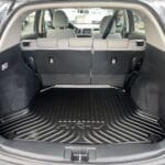 A trunk of a car with the back seats folded down.