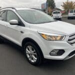 A white suv is parked in the parking lot.