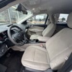 A car with beige leather seats and steering wheel.