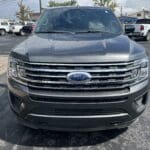 A gray ford expedition parked in the parking lot.