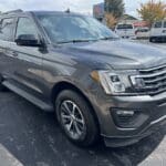 A gray suv parked in the parking lot.