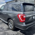 A gray suv parked in the parking lot.