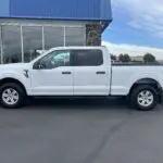 A white truck parked in front of a building.