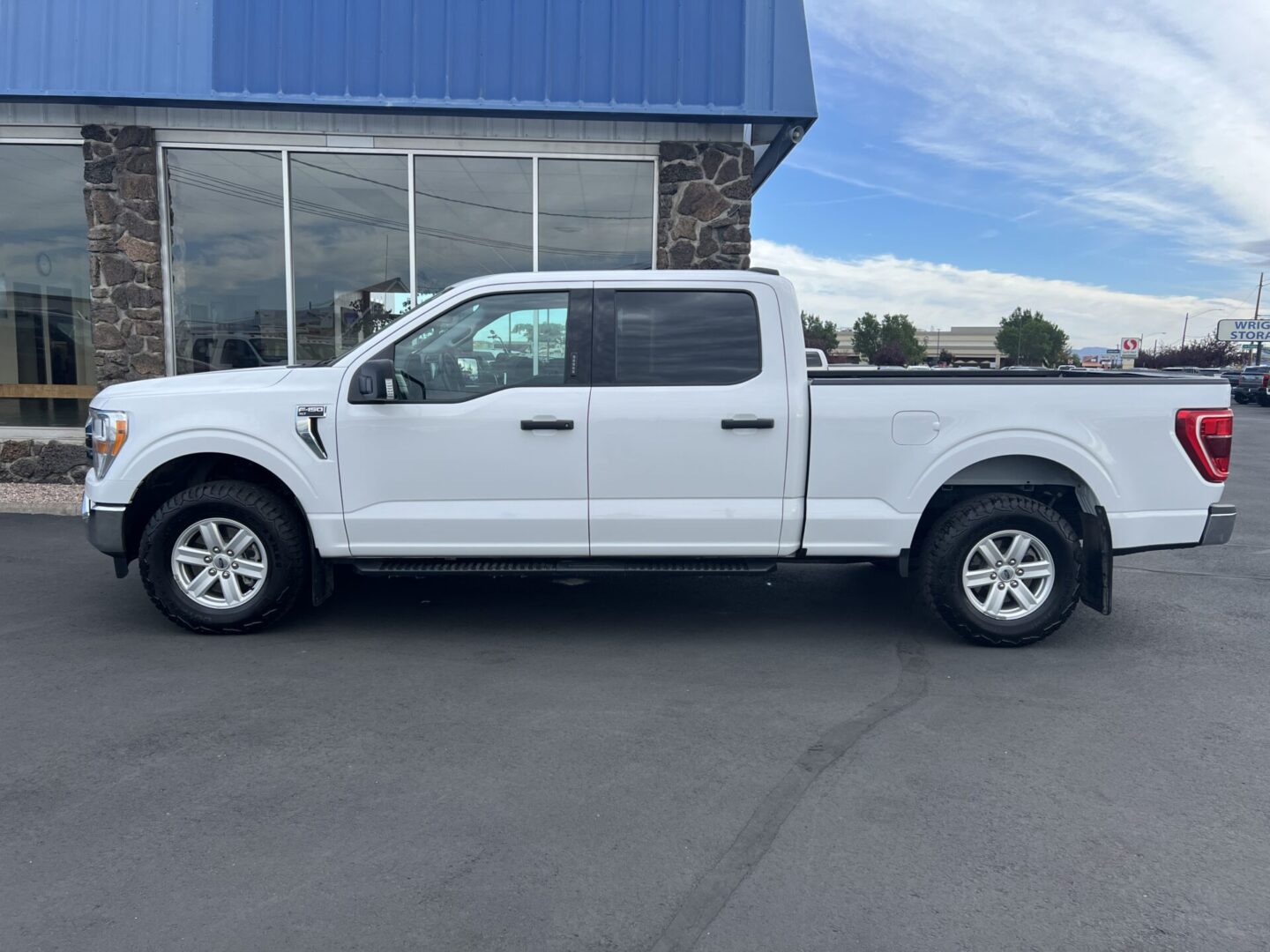 A white truck parked in front of a building.