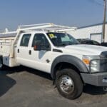 A white truck parked in the lot with other vehicles.