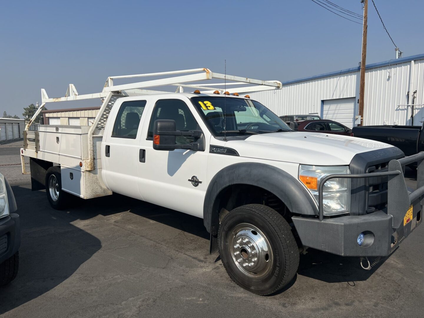 A white truck parked in the lot with other vehicles.