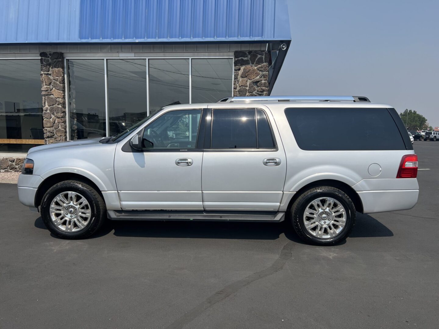 A white suv parked in front of a building.